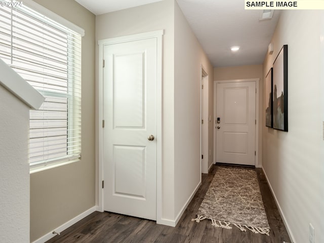 hallway with dark hardwood / wood-style floors