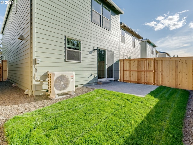 rear view of property with a lawn, ac unit, and a patio