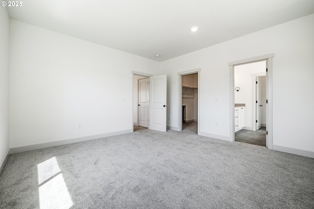 534 Grant St, Umatilla, OR 97882 - unfurnished bedroom with carpet floors, a walk in closet, baseboards, a closet, and recessed lighting