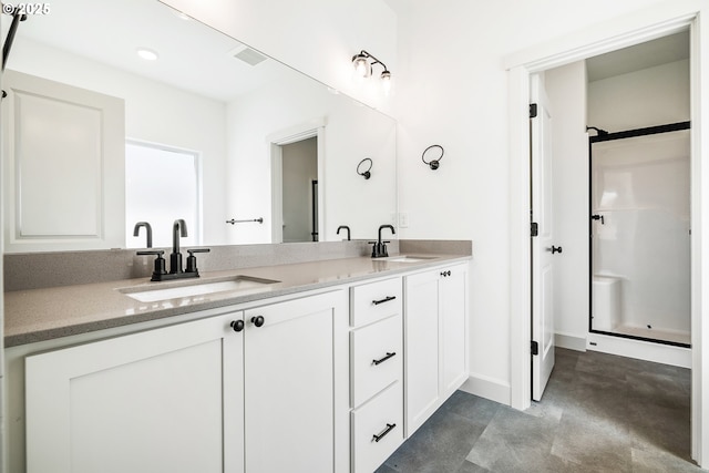 534 Grant St, Umatilla, OR 97882 - full bathroom with double vanity, a shower, recessed lighting, concrete flooring, and baseboards