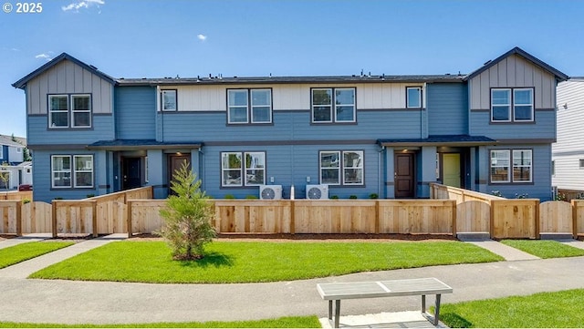 multi unit property featuring a gate, a fenced front yard, and board and batten siding