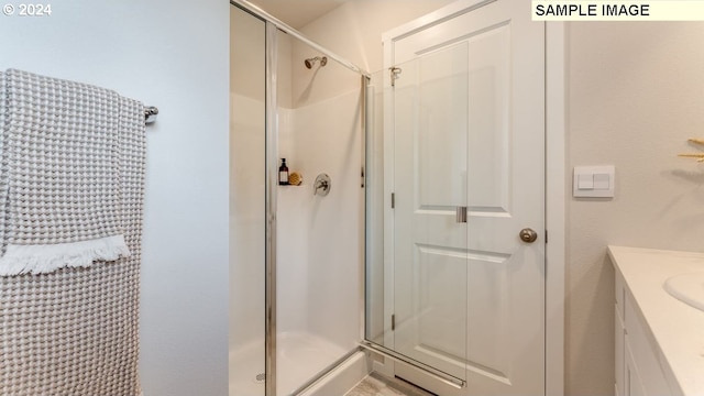 bathroom with vanity and a shower stall