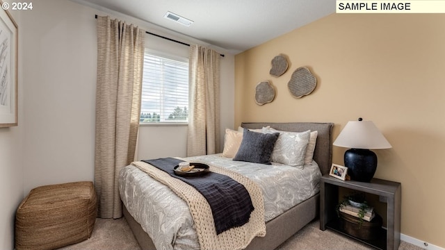 carpeted bedroom with visible vents