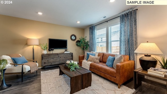living room with wood finished floors, recessed lighting, baseboards, and visible vents