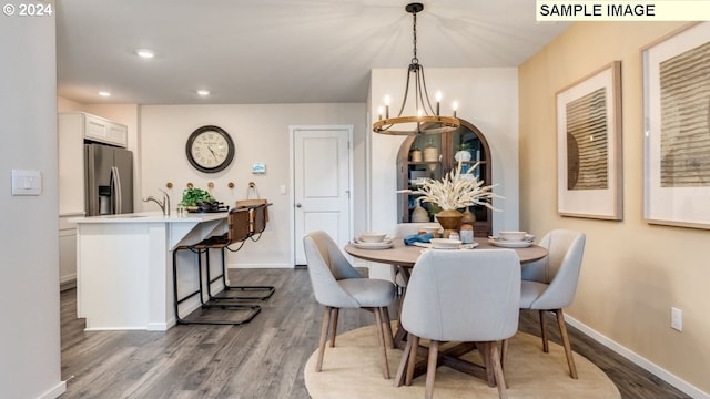 dining area featuring baseboards, dark wood-style flooring, and a chandelier