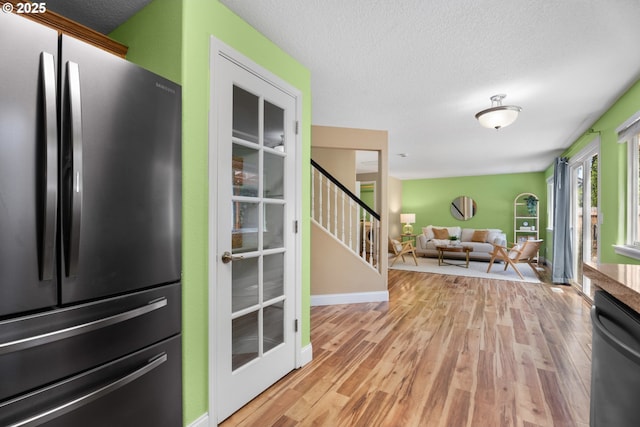 1601 NW 2nd Ave, Battle Ground, WA 98604 - kitchen featuring freestanding refrigerator, dishwasher, light wood finished floors, and a textured ceiling