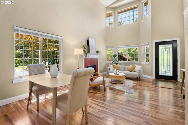 1601 NW 2nd Ave, Battle Ground, WA 98604 - dining space featuring a high ceiling, baseboards, wood finished floors, and a tile fireplace