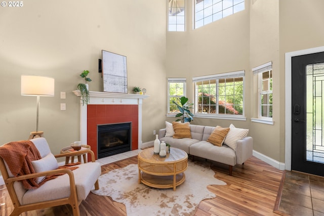 1601 NW 2nd Ave, Battle Ground, WA 98604 - living room with a high ceiling, plenty of natural light, a tile fireplace, wood finished floors, and baseboards