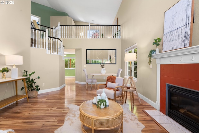 1601 NW 2nd Ave, Battle Ground, WA 98604 - living room with wood finished floors, a tile fireplace, baseboards, and high vaulted ceiling