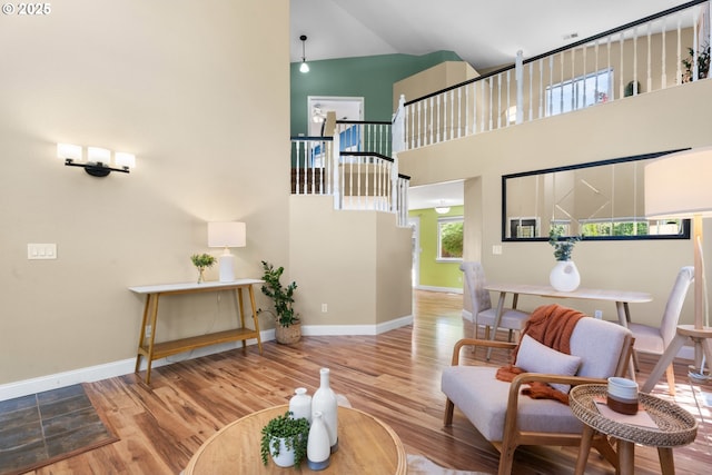 1601 NW 2nd Ave, Battle Ground, WA 98604 - living area featuring a towering ceiling, wood finished floors, and baseboards