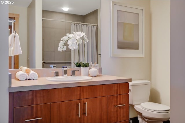 bathroom featuring vanity, toilet, and a shower with shower curtain