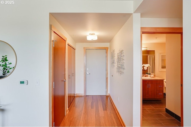 corridor featuring sink and hardwood / wood-style floors