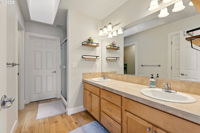 8503 SE 139th Ct, Portland, OR 97236 - bathroom featuring hardwood / wood-style floors, double vanity, and a shower stall