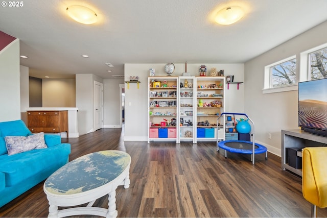 playroom with wood finished floors and baseboards