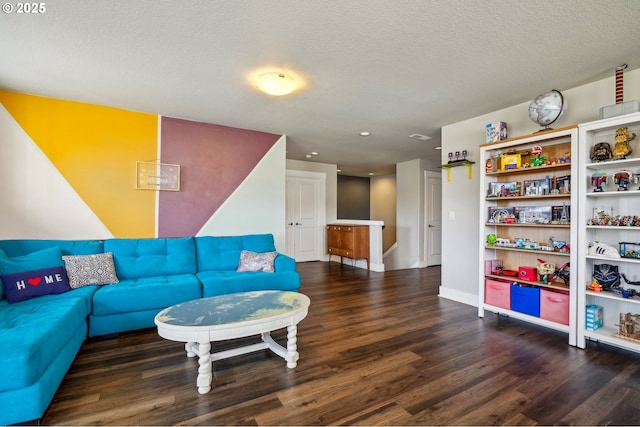 living room with baseboards, a textured ceiling, and wood finished floors