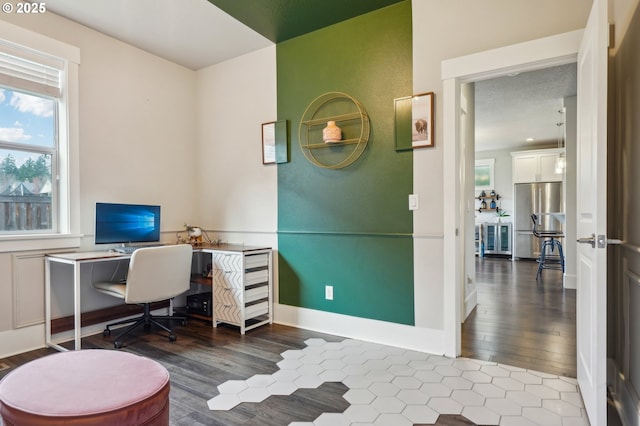 office area with baseboards and wood finished floors