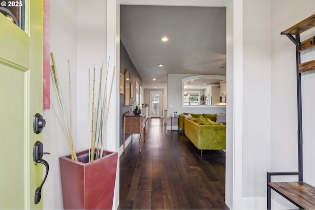 entrance foyer with recessed lighting, arched walkways, and wood-type flooring