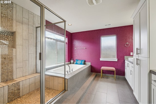 bathroom featuring vanity, visible vents, tile patterned flooring, a shower stall, and a bath