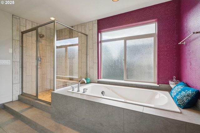 bathroom featuring a garden tub and a stall shower