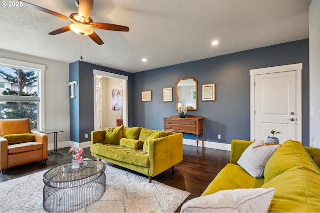 living room featuring a ceiling fan, wood finished floors, baseboards, recessed lighting, and a textured ceiling