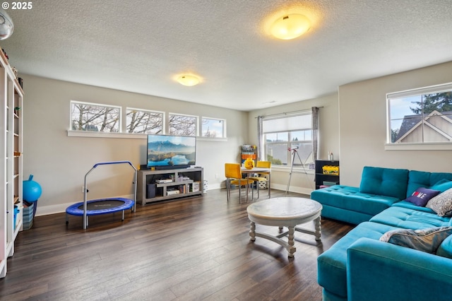 living area featuring hardwood / wood-style flooring, baseboards, and a textured ceiling