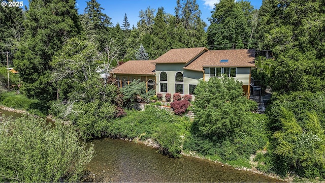 91060 Leashore Dr, Vida, OR 97488 - view of front of home with stairs, a wooded view, and a shingled roof