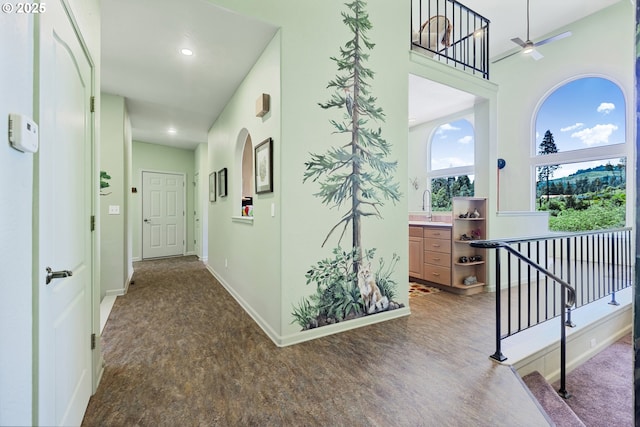 91060 Leashore Dr, Vida, OR 97488 - corridor with baseboards, a sink, an upstairs landing, and recessed lighting