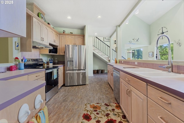 91060 Leashore Dr, Vida, OR 97488 - kitchen featuring stainless steel appliances, a sink, under cabinet range hood, decorative backsplash, and recessed lighting