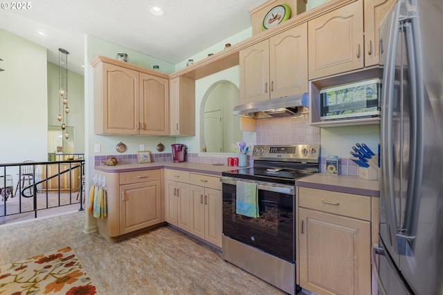 91060 Leashore Dr, Vida, OR 97488 - kitchen with stainless steel appliances, under cabinet range hood, light brown cabinets, light countertops, and recessed lighting