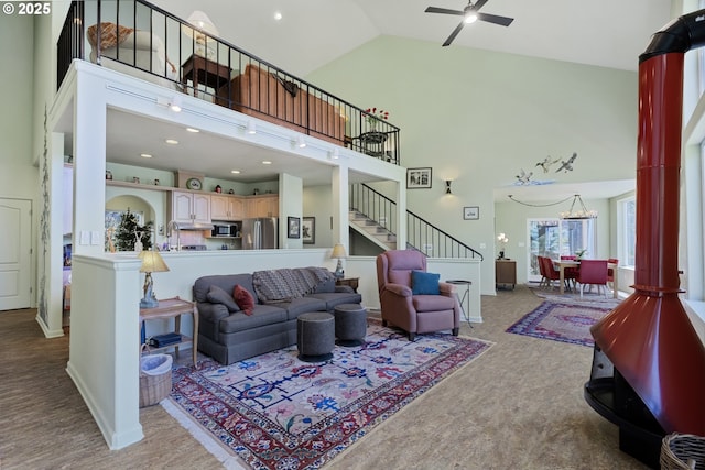91060 Leashore Dr, Vida, OR 97488 - living area with high vaulted ceiling, stairs, carpet floors, a ceiling fan, and baseboards