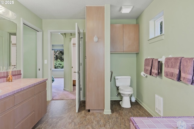 91060 Leashore Dr, Vida, OR 97488 - bathroom featuring toilet, baseboards, and vanity