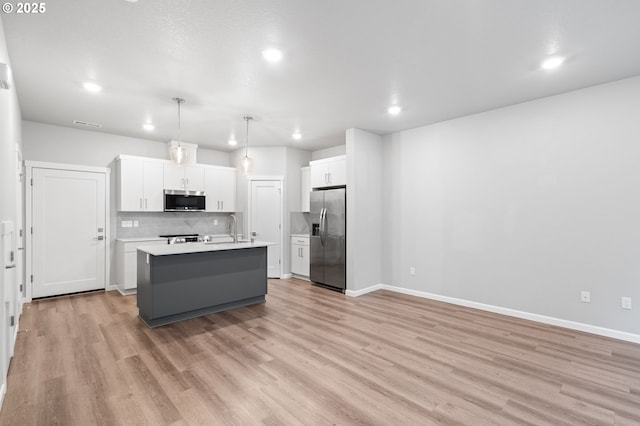 16314 NE 20th St, Vancouver, WA 98684 - kitchen with an island with sink, light countertops, white cabinetry, tasteful backsplash, and stainless steel appliances
