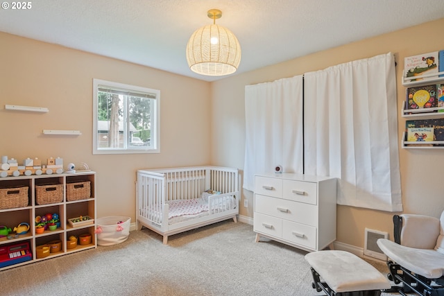 164 Yelton Dr, Longview, WA 98632 - carpeted bedroom featuring visible vents, baseboards, and a nursery area