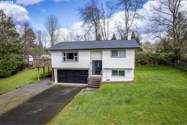 164 Yelton Dr, Longview, WA 98632 - split foyer home featuring a garage, a front yard, driveway, and a chimney