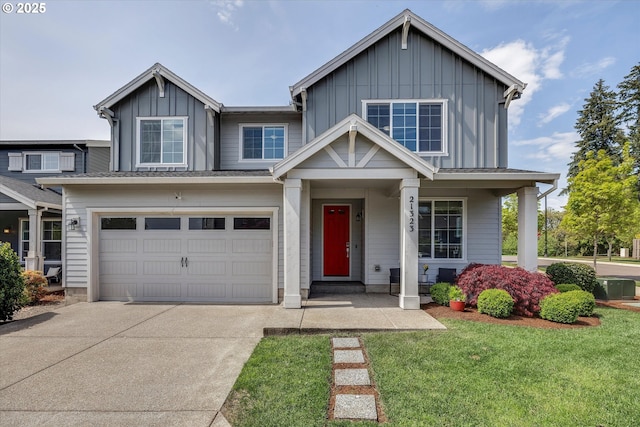 view of front of property featuring a garage, board and batten siding, a front yard, covered porch, and driveway