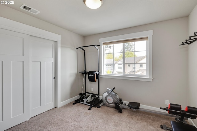 exercise area with baseboards, carpet flooring, and visible vents