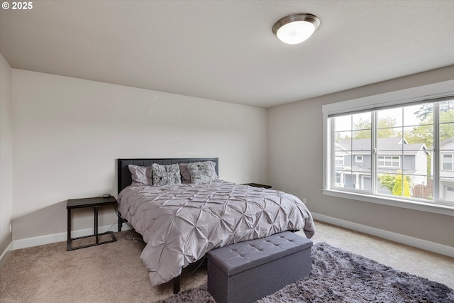 carpeted bedroom featuring baseboards