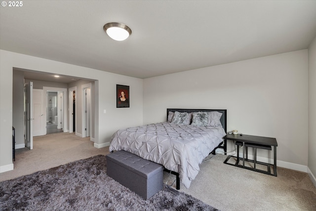bedroom featuring baseboards and carpet