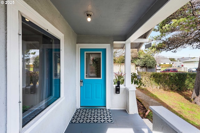 doorway to property featuring stucco siding