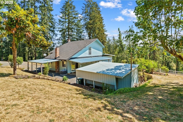 37276 Camp Creek Rd, Springfield, OR 97478 - view of property exterior featuring a chimney, metal roof, and central AC