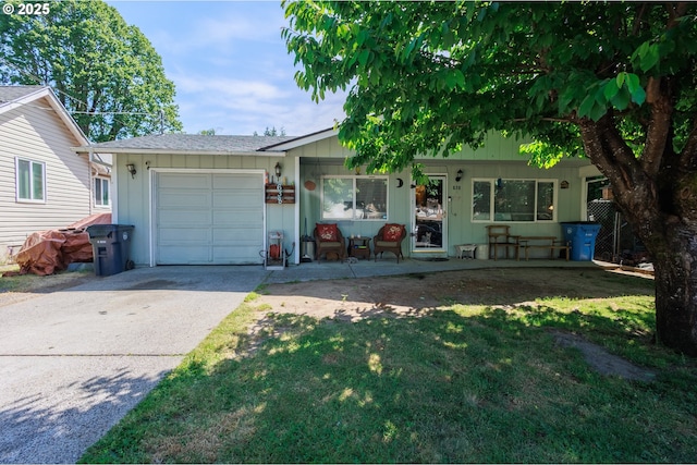 638 SE Polk St, Camas, WA 98607 - view of front of house featuring a garage, driveway, a front lawn, board and batten siding, and a shingled roof