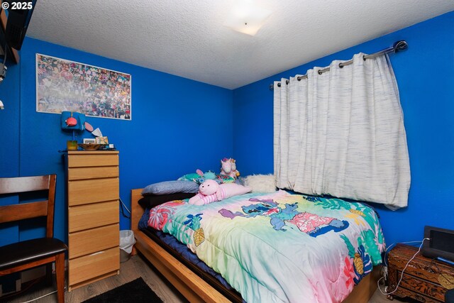 638 SE Polk St, Camas, WA 98607 - bedroom featuring wood finished floors and a textured ceiling