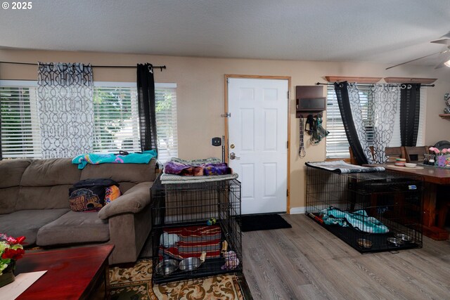 638 SE Polk St, Camas, WA 98607 - living area featuring wood finished floors, a textured ceiling, baseboards, and a ceiling fan