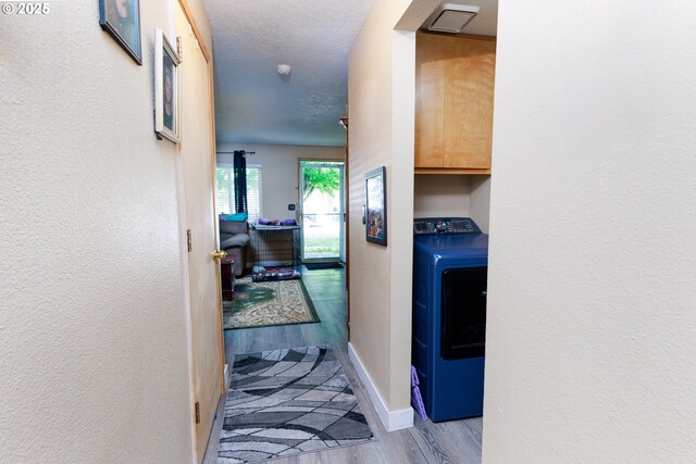 638 SE Polk St, Camas, WA 98607 - corridor featuring washer / dryer, wood finished floors, baseboards, and a textured wall