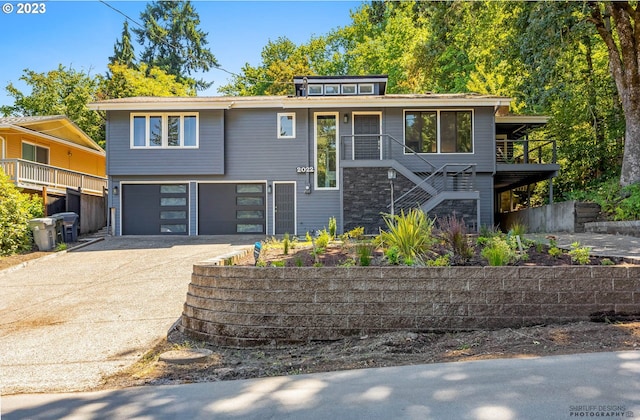 2022 Floral Hill Dr, Eugene, OR 97403 - view of front of property with an attached garage, concrete driveway, and stairs