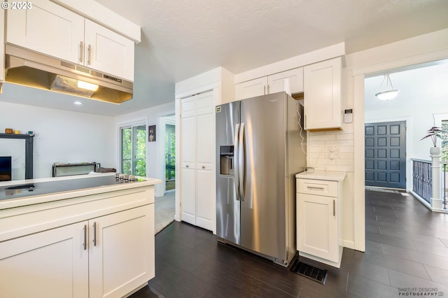 2022 Floral Hill Dr, Eugene, OR 97403 - kitchen with stainless steel dishwasher, a sink, under cabinet range hood, a peninsula, and white cabinetry