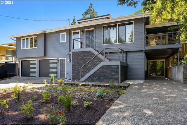 2022 Floral Hill Dr, Eugene, OR 97403 - view of front of home featuring driveway, an attached garage, and stairs
