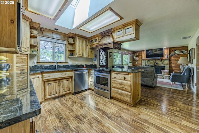 40211 Deerhorn Rd, Springfield, OR 97478 - kitchen with stainless steel appliances, open shelves, wood walls, a peninsula, and a sink