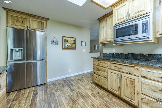 40211 Deerhorn Rd, Springfield, OR 97478 - kitchen with appliances with stainless steel finishes, wood finished floors, baseboards, and dark stone counters