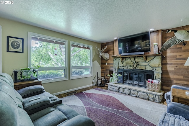 40211 Deerhorn Rd, Springfield, OR 97478 - living area featuring baseboards, a stone fireplace, wooden walls, and a textured ceiling